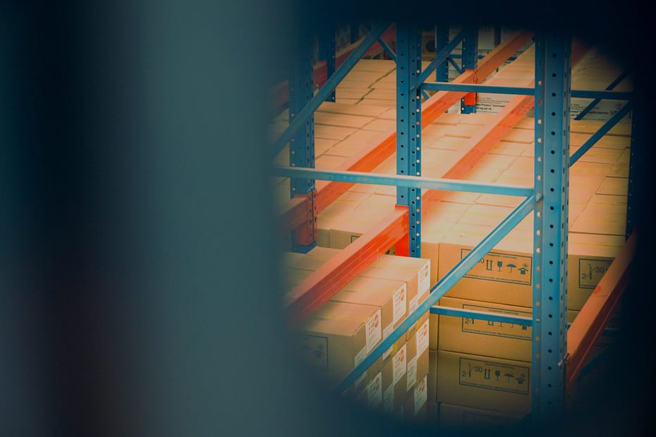 selective focus photography of brown boxes on gray shelf